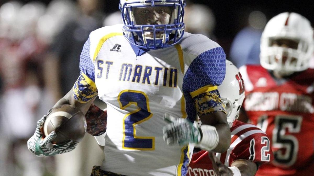 St. Martin senior receiver Kalem Reddix breaks a final tackle attempt to score the Yellowjackets first touchdown against Harrison Central.