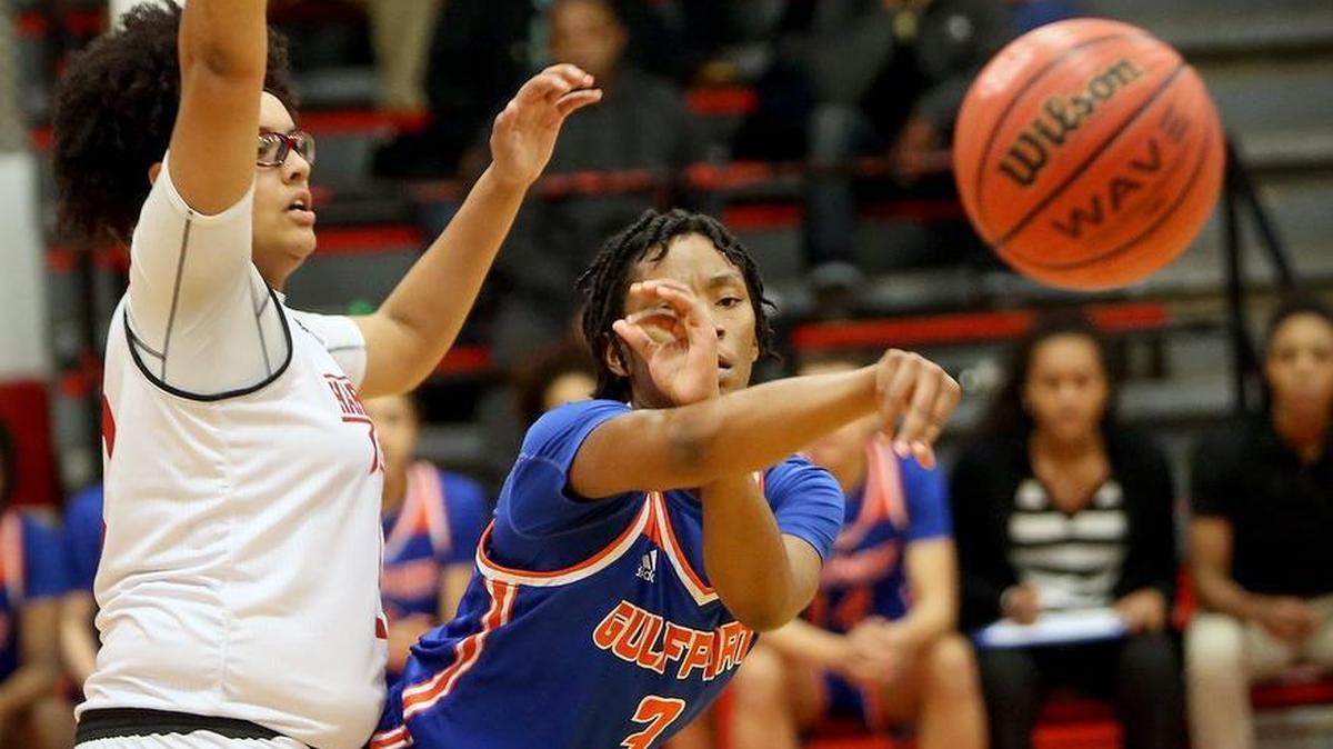 Gulfport's Dywana Parker passes the ball while guarded by Harrison Central's Olivia Brooks on Friday, January 5, 2018, at Harrison Central High School.