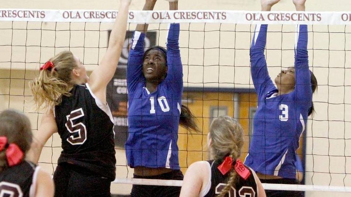 OLA's Mary Rimmer knocks the ball between Resurrection's Icy Walley and Jada Williams, Oct. 27. Both Rimmer and Walley were recently named to the MAC all-star volleyball match.