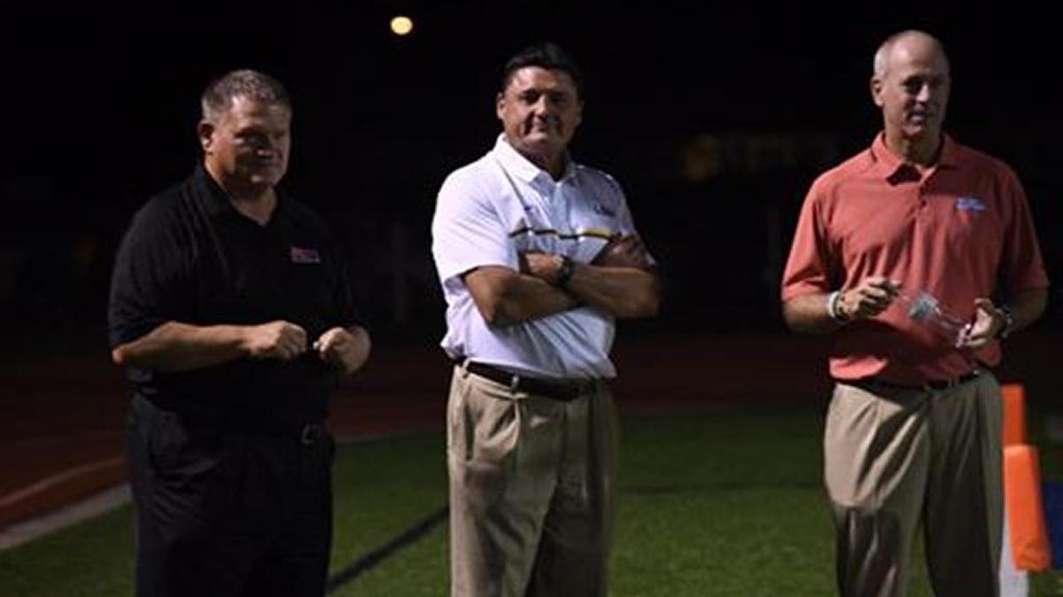 LSU interim coach Ed Orgeron, middle, and Ole Miss co-offensive coordinator Dan Werner, right, visited Bay St. Louis on Friday night to see LSU QB commit Myles Brennan and the St. Stanislaus Rockachaws play Bay High.