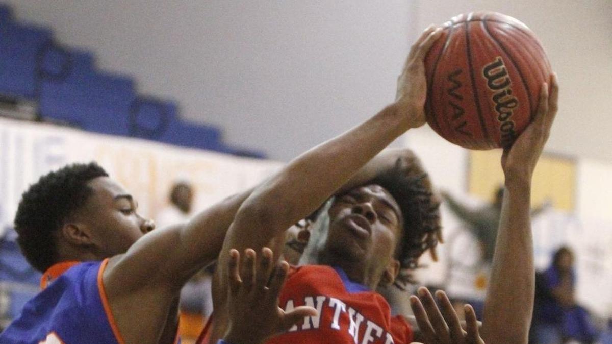 Gulfport's Greg Brown fouls Pascagoula's D'yasmond Booker during the first quarter of their game at Bert Jenkins Gym in Gulfport on Tuesday, Nov. 28, 2017.