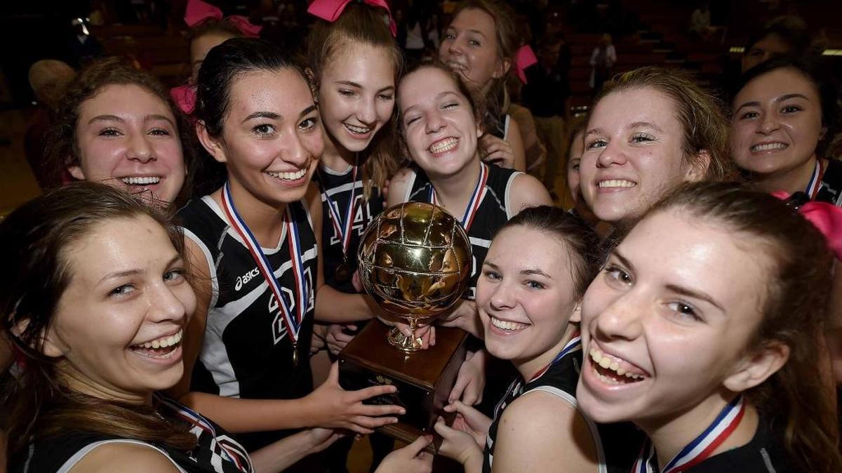 The Our Lady Academy Crescents are all smiles with the trophy after beating Resurrection for the Class I state title on Oct. 29, 2016, in the MHSAA State Volleyball Championship at Millsaps College in Jackson.