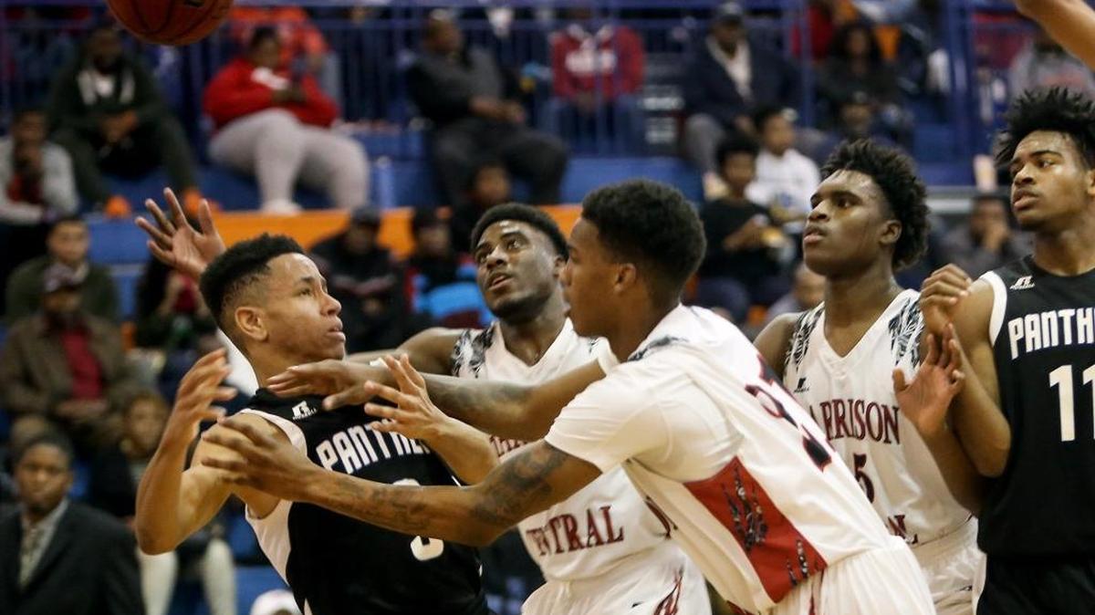 Pascagoula's Jordan Robinson, left, is pushed back as players scramble for a rebound during the Adidas Holiday Classic final on Dec. 29 at Gulfport High.