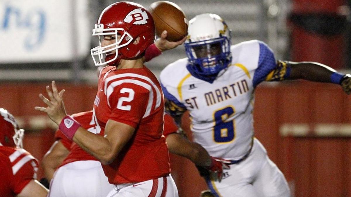Biloxi quarterback Tucker Thomas looks for a receiver as St. Martin's Donte' Starks provides the pressure on Oct. 14, 2016, in Biloxi.