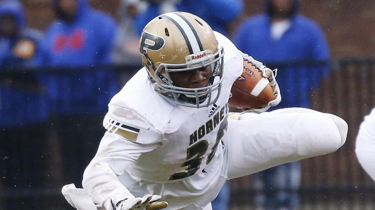 Poplarville running back Jesse Pernell goes airborne as he is tackled by Lafayette linebacker Dillon Woods (2) during the first half of the MHSAA Class 4A football championship game in Starkville, Saturday.