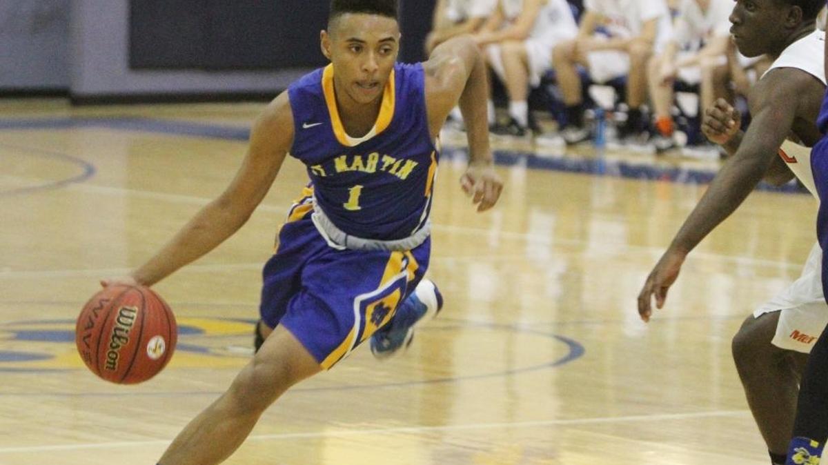 St. Martin's Daetren Bivens dribbles past a McGill Toolen defender during the third quarter of their Joe Barlow Thanksgiving Invitational basketball tournament game on Tuesday, Nov. 22, 1016. Bivens helped push the Yellow Jackets past Laurel on Wednesday.