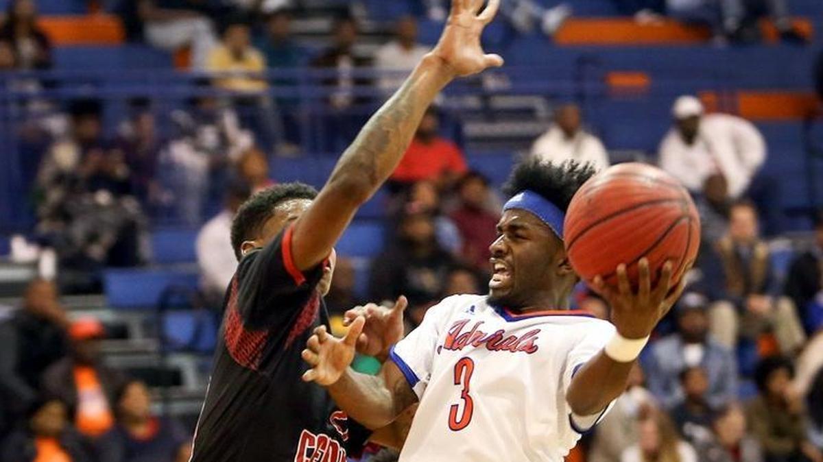 Gulfport's Chad Crenshaw attempts a shot while guarded by Harrison Central's Nikko Pittman during the second night of the Adidas Holiday Classic on Dec. 28 at Gulfport High.