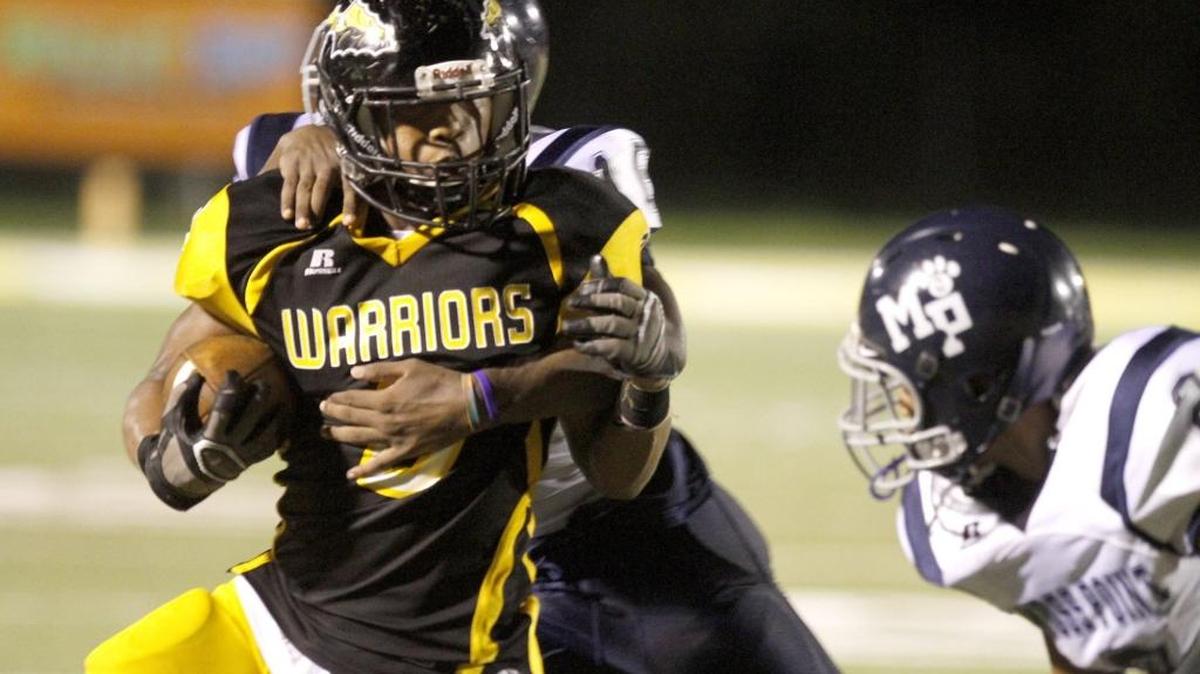 D’Iberville running back Devon Dixson is brought down by a host of Moss Point Tigers during Friday’s jamboree in D'Iberville. The Warriors open the year as the Sun Herald’s top-ranked team.
