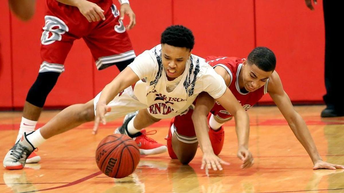 Harrison Central's Marquz Clay, left, and Biloxi's Roshaun Jones Jr. dive for a loose ball on Friday, January 12, 2018, at Harrison Central High.