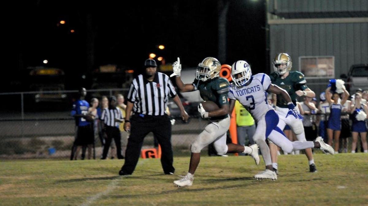 Hornets running back Austin Bolton heads for the goal line Friday night against the Tomcats. The Hornets brought home a close win 38-35, bringing their standing to 3-1 so far this year.