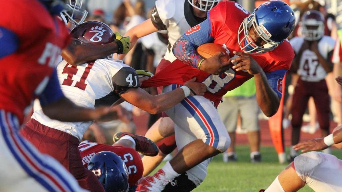 Pass Christian running back Tionne Frost runs through a tackle by Long Beach's Marty Moore during the first quarter of their game at Pass Christian on Thursday, Aug. 17, 2017. PCHS is ranked No. 9 in this week’s Sun Herald Top 10.