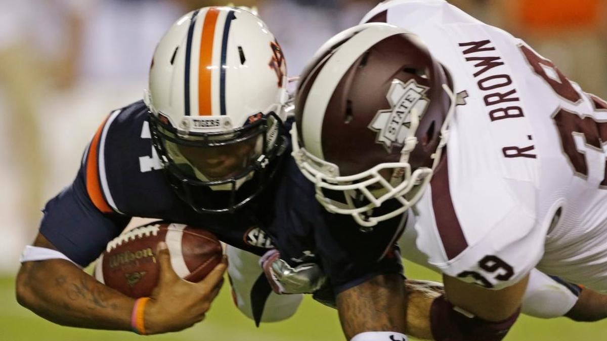 Auburn quarterback Nick Marshall (14) is sacked by Mississippi State linebacker Richie Brown (39) in the second half of an NCAA college football game in Auburn, Ala., Saturday, Sept. 14, 2013. Auburn beat Mississippi State 24-20.