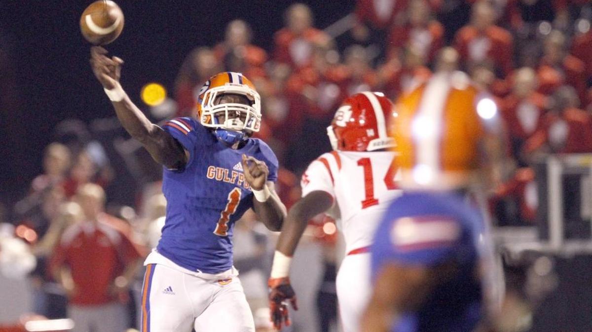 Gulfport quarterback Cleveland Ford throws a touchdown pass to Jalen Knight as Biloxi's Brandon Walker provides pressure at Milner Stadium in Gulfport, Friday, Nov. 4, 2016.