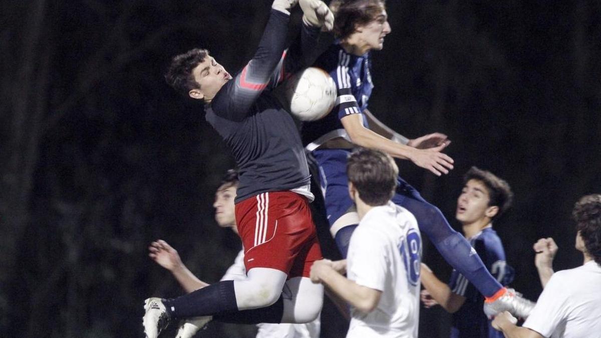 Resurrection goal keeper Bronson Raworth leaps to block a shot on goal against St. Patrick.