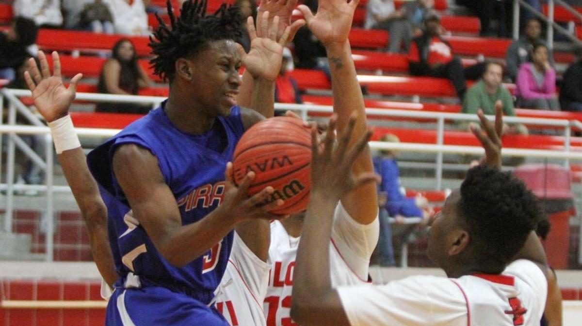Pass Christian's Tezz Green drives under the basket before loosing the ball to Biloxi's Zhi Hopson, right, during the second quarter of their game at Biloxi High School on Tuesday, Dec. 13, 2016. Green led PCHS past Long Beach on Tuesday.