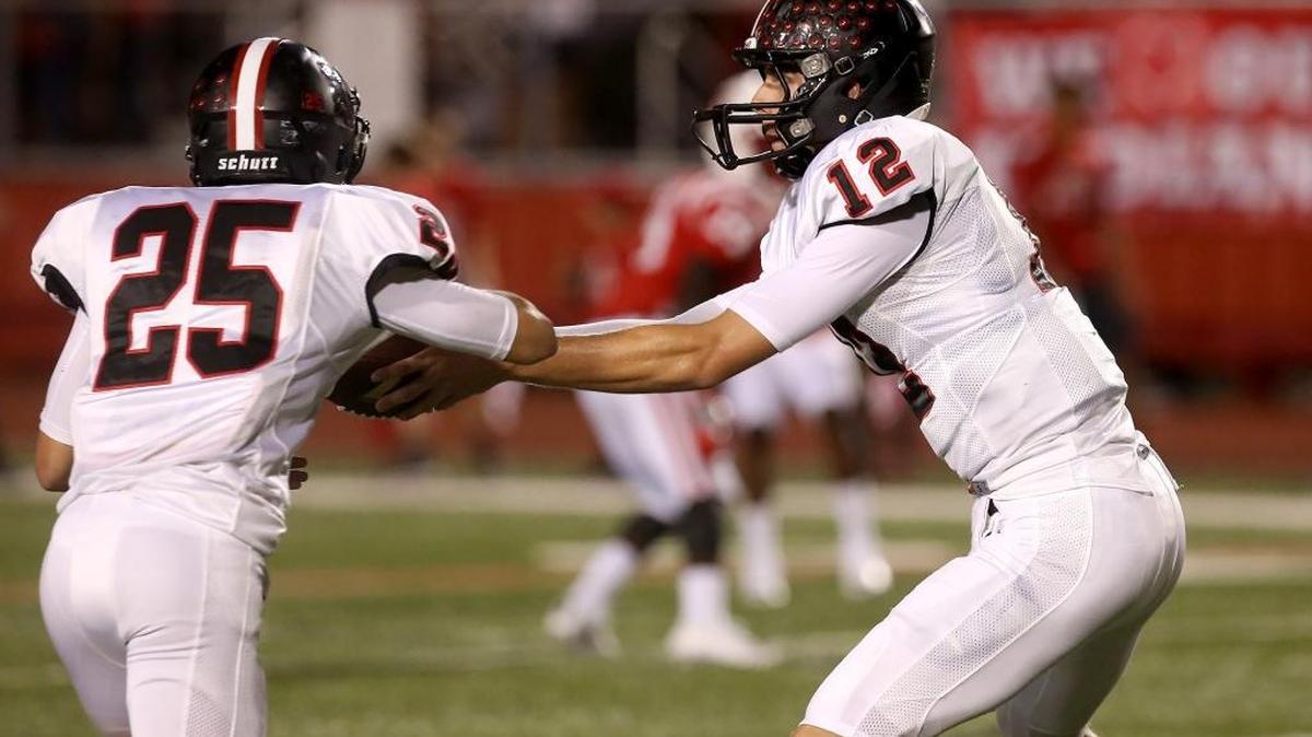 St. Stanislaus quarterback Myles Brennan hands the ball off to Taylor Necaise during the 2016 Shrimp Bowl on Aug. 19 in Biloxi.