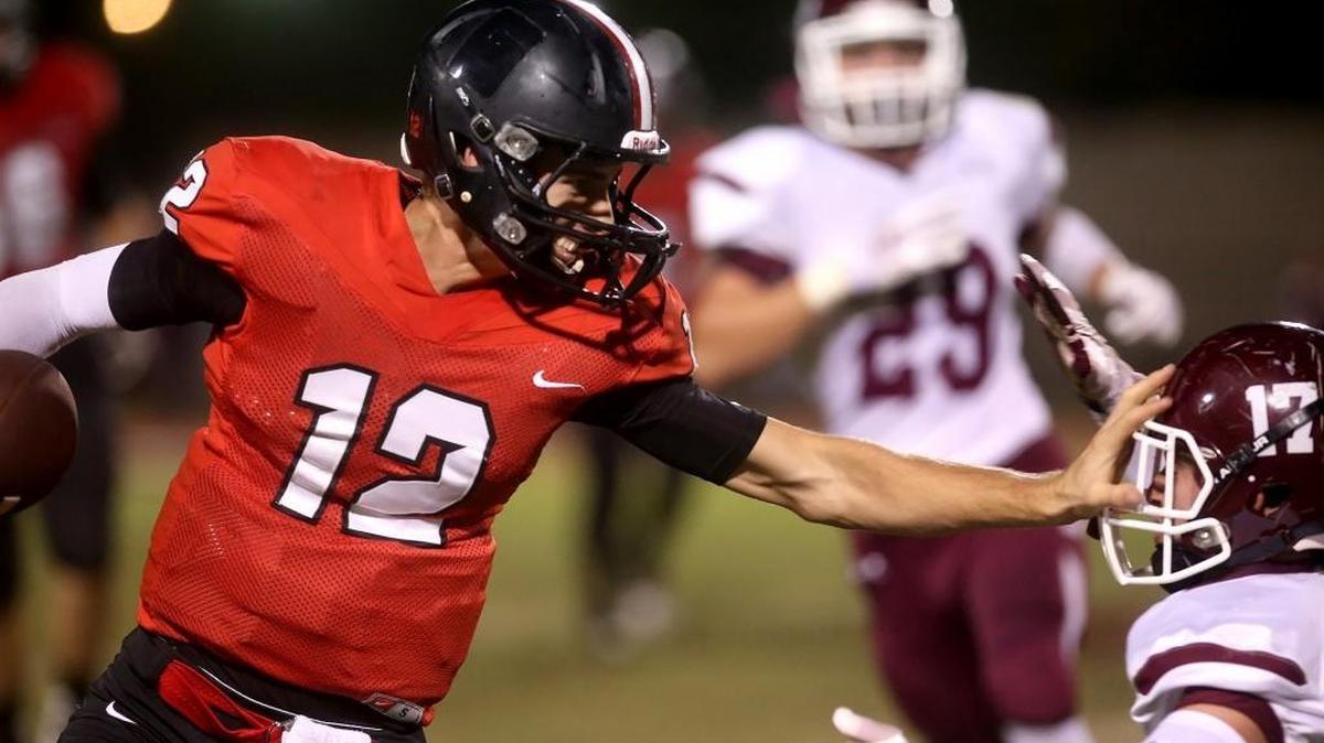 St. Stanislaus quarterback Myles Brennan runs the ball past East Central's Taylor Carpenter on Friday, October 14, 2016, in Bay St. Louis. SSC opened the Class 4A playoffs on Friday against Greene County.