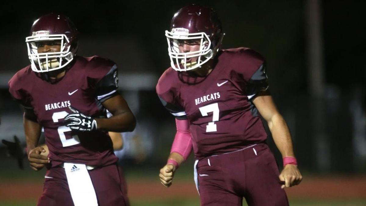 Long Beach quarterback Cade Crosby, right, celebrates after running the ball into the end zone for a touchdown against Wayne County on Oct. 6, 2017, at Long Beach High.