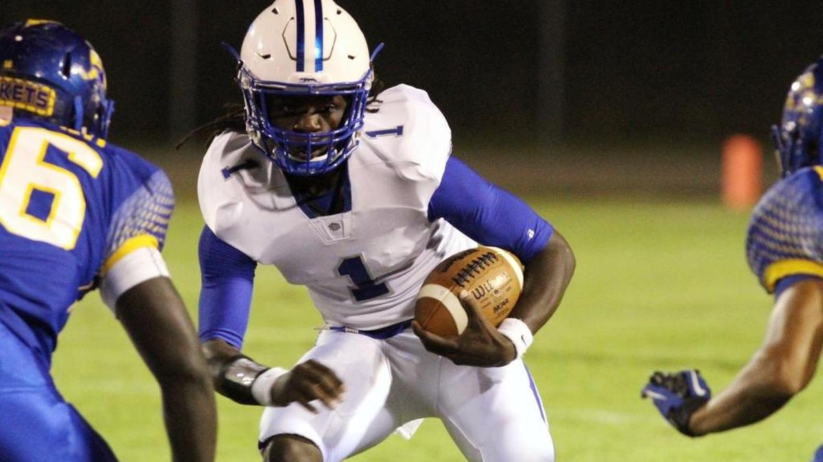 Ocean Springs quarterback Malcolm MaGee hits a hole during against St. Martin at Joe Barlow Stadium in St. Martin on Oct. 21, 2016.
