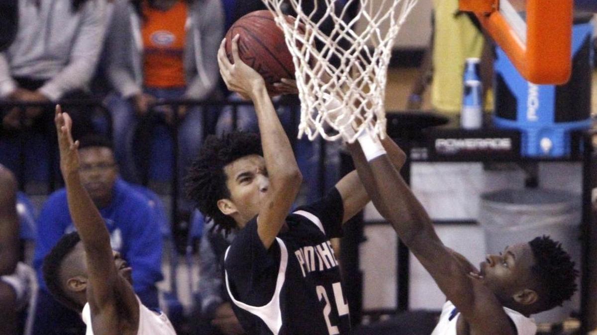 Pascagoula's Jayden McCorvey splits two Meridian defenders to take a shot during the Gulfport Hardwood Holiday Classic, Thursday, Dec. 29, 2016. Provine eliminated Pascagoula on Tuesday.