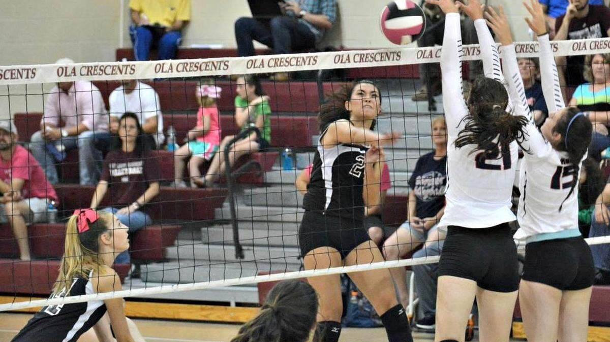 Our Lady Academy's Alia Tayara slams the ball between Hancock's double block Wednesday night at OLA. The Lady Crescents defeated visiting HHS 3-2 (25-17, 10-25, 25-21, 20-25, 15-5).