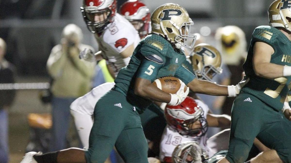 Poplarville running back Austin Bolton follows his blockers through the hole against Florence during 4A South State title game in Poplarville Friday.