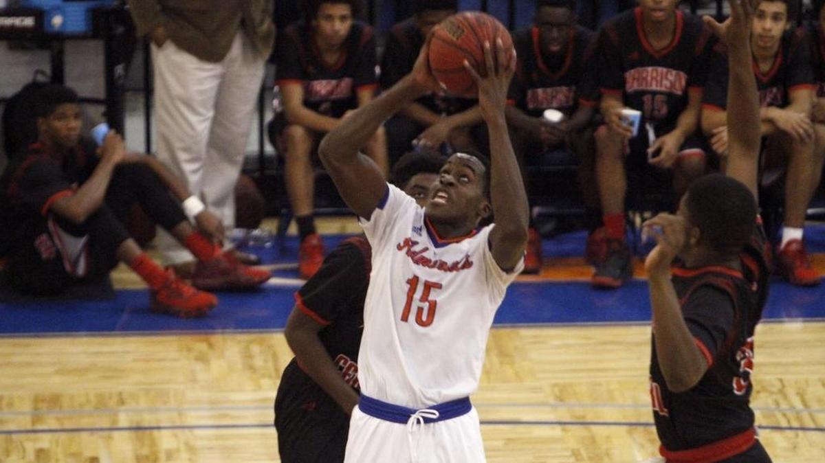 Gulfport's Derick Hall splits two Harrison Central defenders to score two points during basketball game Friday, Jan. 6, 2017. Hall helped boost the Admirals past Pass Christian on Thursday.