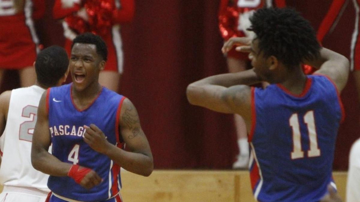 Pascagoula’s Dequan Weatherspoon (4) and Dyasmond Booker react to a traveling call against Biloxi during the second quarter of their game at the Biloxi High gym on Dec. 3, 2017.