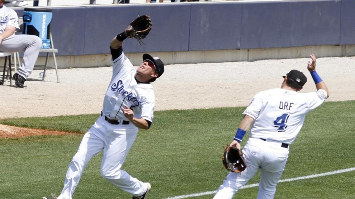 Biloxi left fielder Kyle Wren catches a ball in foul territory as Nathan Orf gives ground earlier this season.