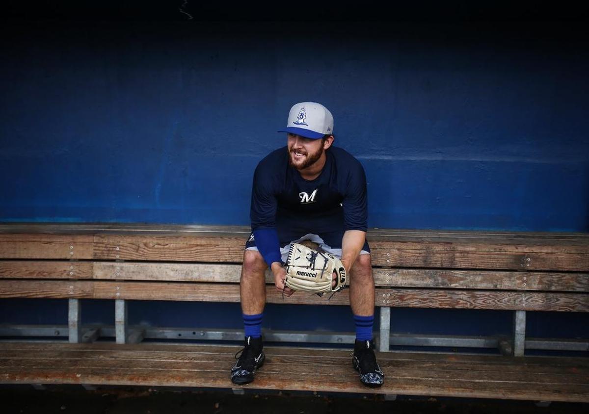 Shuckers relief pitcher Bubba Derby sits in the dugout before practice. Photographer’s comments: Unlike other sports photos from this year, this is a portrait. I like Derby’s casual stance combined with the deep blue of the wall and the texture of the wood.