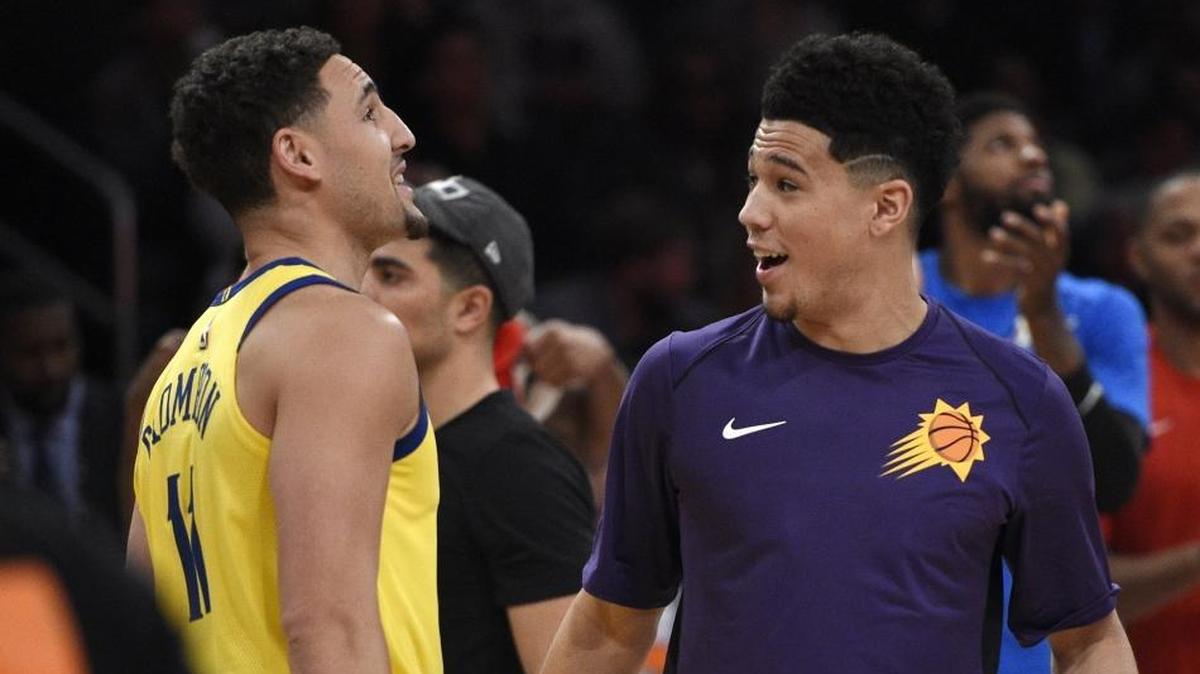 Phoenix Suns' Devin Booker, right, is congratulated by Golden State Warriors' Klay Thompson after winning the NBA All-Star basketball 3-Point contest Saturday in Los Angeles.