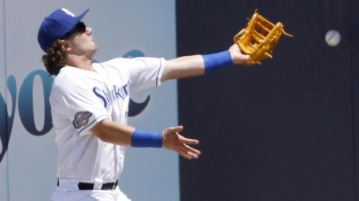 Shuckers right fielder Clint Coulter can't make the catch of a ball hit to the wall during game between the Shuckers and Braves Sunday in Biloxi.