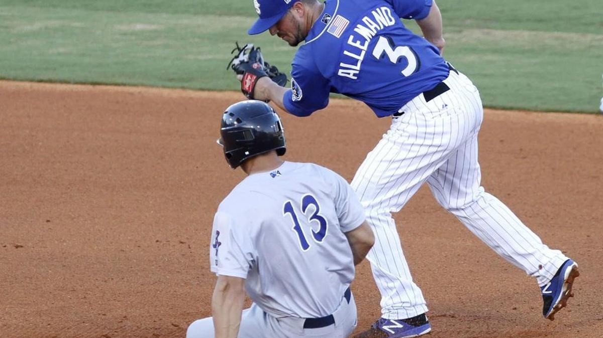 The ball seems to stick on the cap of Shuckers second baseman Blake Allemand as Pensacola's Nick Senzel stretches a single into a double at MGM Park, Thursday, July 6, 2017.