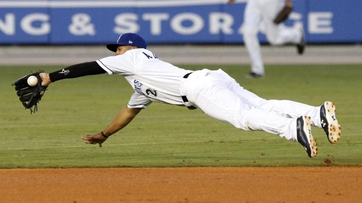 Shucker shortstop Angel Ortega makes a diving stop of a ground ball against Mobile, Saturday night.