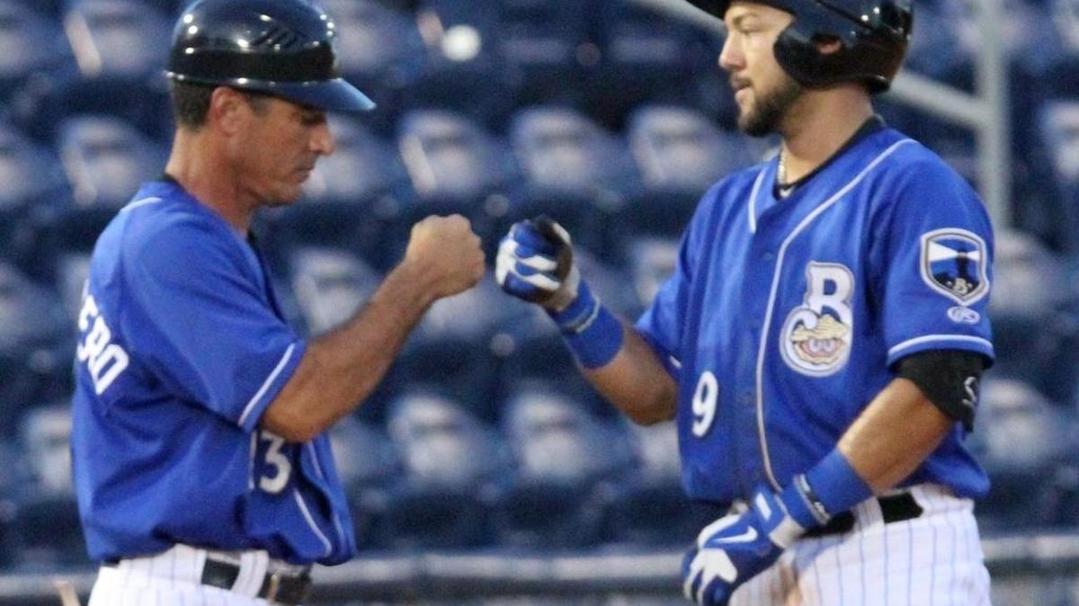 Biloxi Shuckers manager Mike Guerrero greets Javier Betancourt after hitting a triple against Mobile during their Southern League game at MGM Park in Biloxi on Aug. 17, 2016.