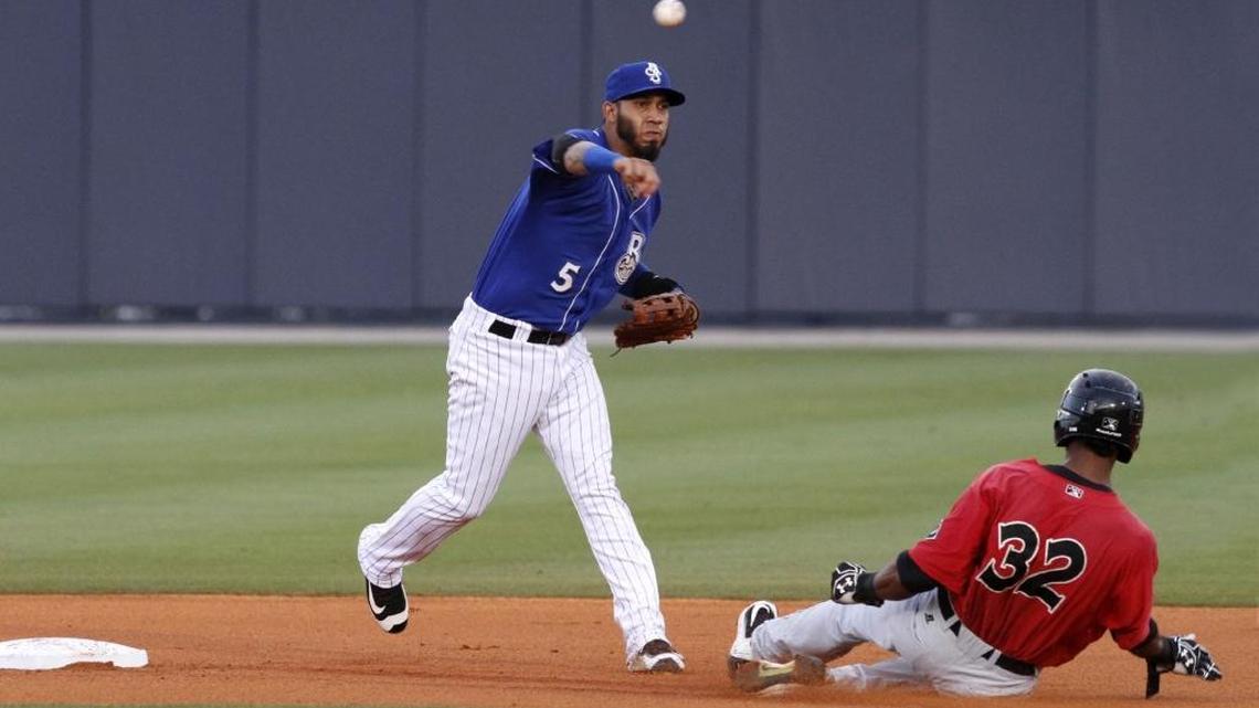 TIM ISBELL/SUN HERALD Biloxi shortstop Gabriel Noriega turns to as Birmingham's Eudy Pina slides into second, Monday, June 13, 2006.