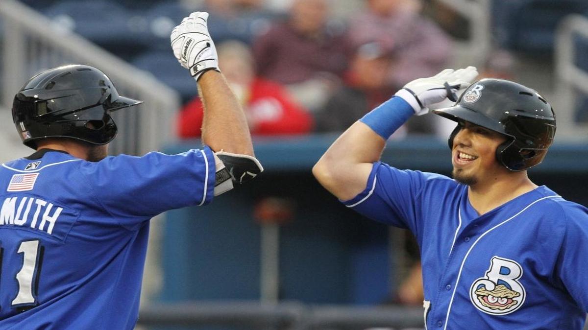 Biloxi Shuckers’ Jacob Nottingham is greeted by Dustin DeMuth. The Shuckers beat Montgomery 2-1 on Saturday.
