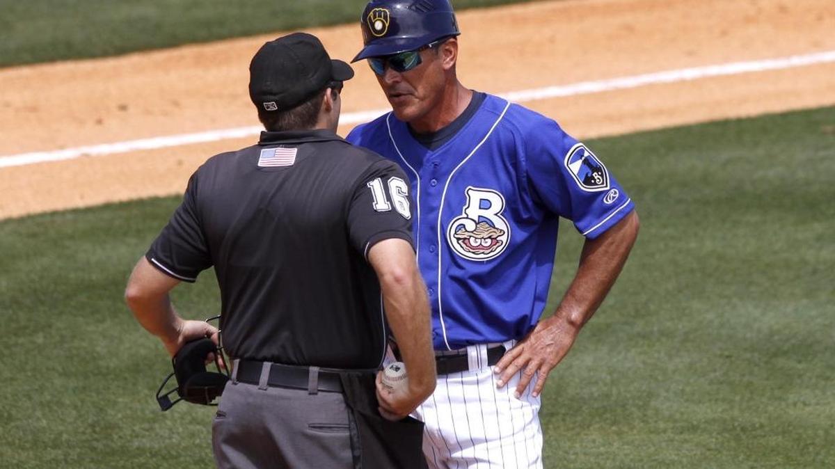 Biloxi Shuckers manager Mike Guerrero discusses a call with umpire Jason Starkovich on Sunday at MGM Park in Biloxi.