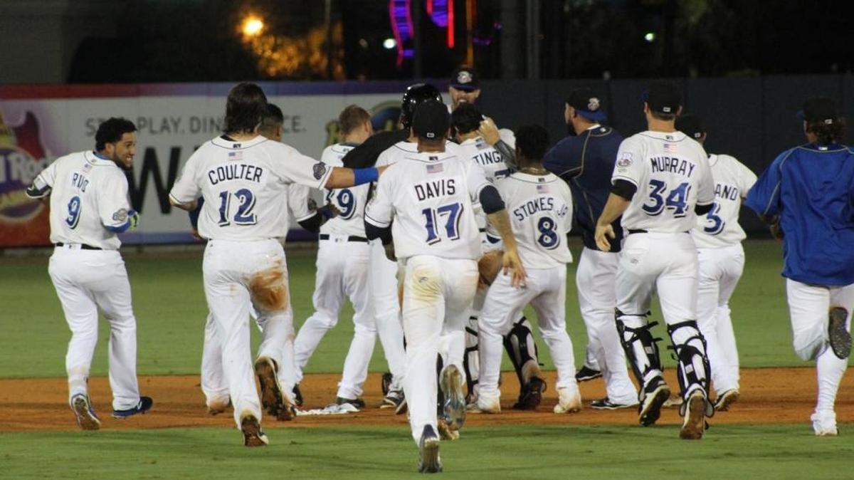 Shuckers players run out to Dustin DeMuth after his walk-off double to give Biloxi a 3-2 win over Tennessee on Thursday night at MGM Park.