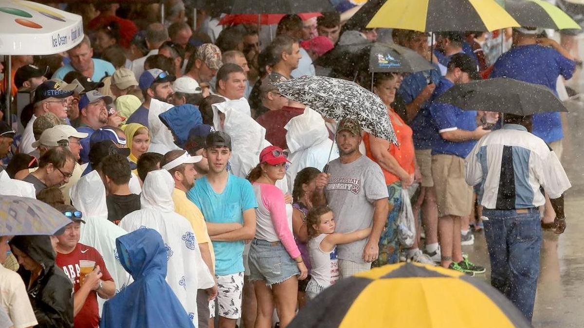 Fans try to stay dry as a thunderstorm rolls through Biloxi in 2015. Thursday’s Biloxi Shuckers game against the Mississippi Braves has been postponed until Friday due to weather.