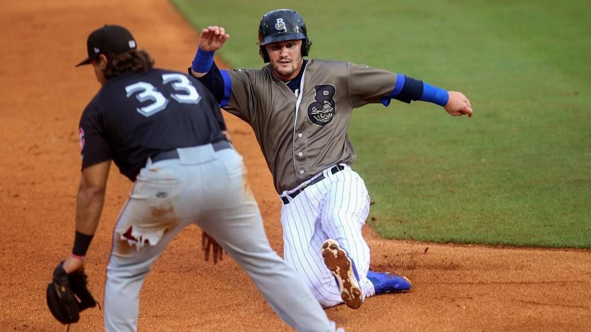 Shuckers outfielderfielder Clint Coulter slides into third base manned by Chattanooga Lookouts’ T.J. White on Monday, May 22, 2017, in Biloxi.