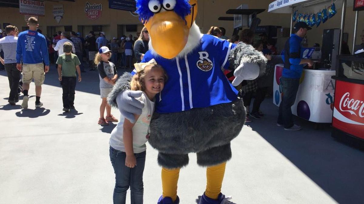 The Biloxi Shuckers’ mascot, Schooner the Seagull, poses with a fan during the 2016 season at MGM Park.