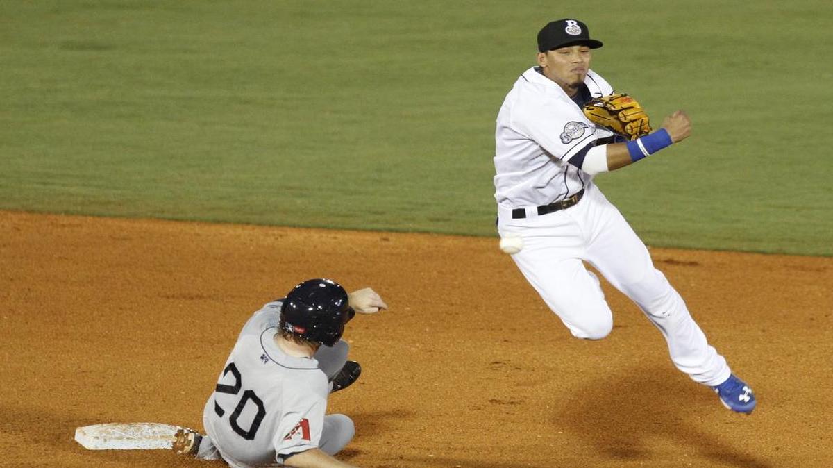 Biloxi Shuckers shortstop Orlando Arcia leaps over Mobile's A. J. Schugel to turn a double play June 10, 2015.