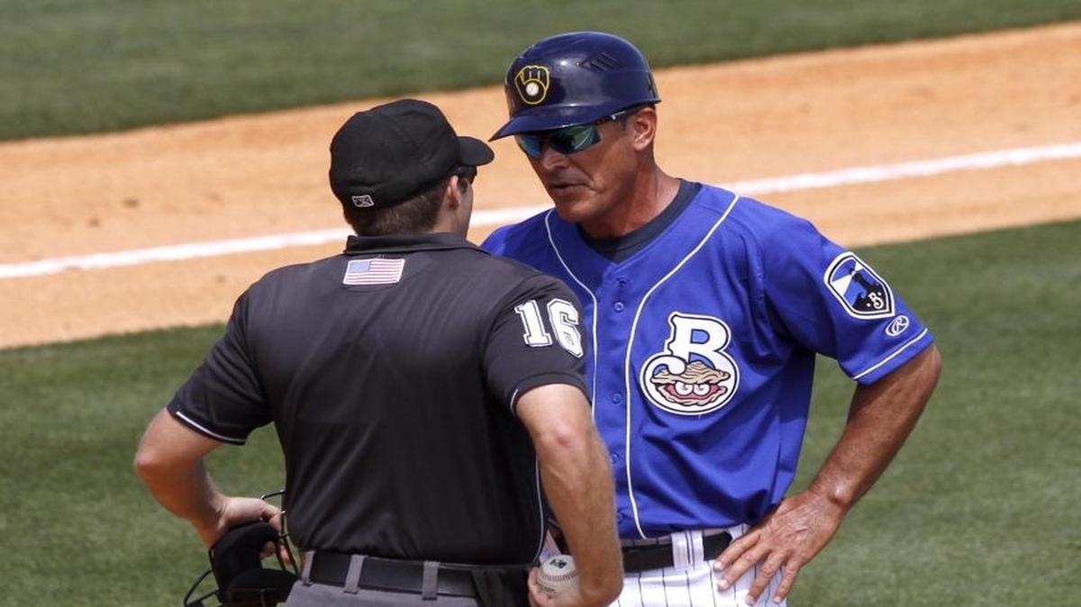 Biloxi Shuckers manager Mike Guerrero discusses a call with umpire Jason Starkovich.