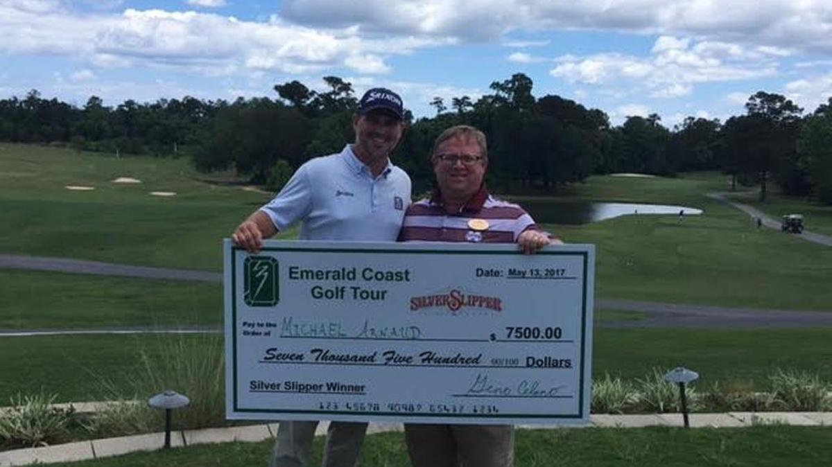Michael Arnaud shows off his winnings as Diamondhead Country Club Director Chris Altese looks on. Arnaud won the Silver Slipper Emerald Coast Golf Tour Pro Classic.