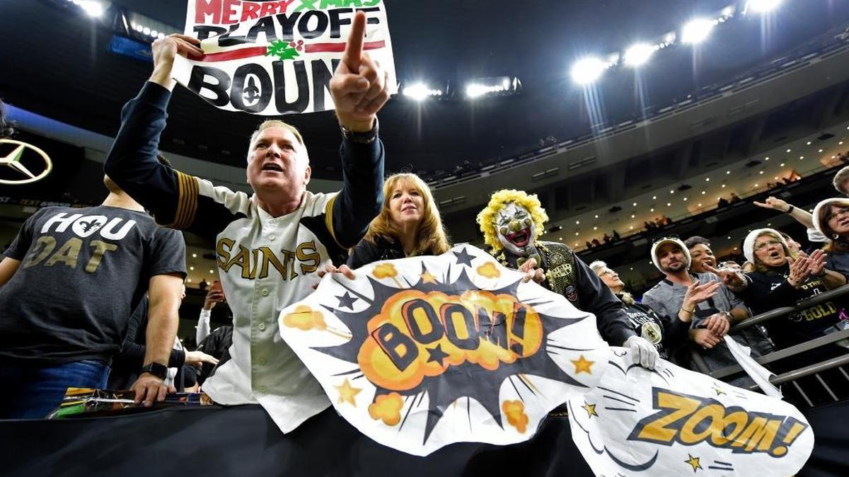 New Orleans Saints fans celebrate after the Saints won 23-13, clinching a playoff berth.
