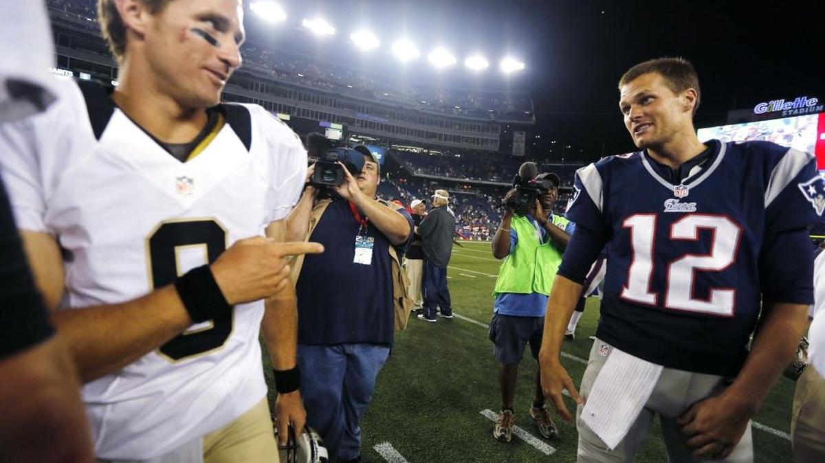In this Aug. 9, 2012, file photo, New Orleans Saints quarterback Drew Brees (9) points at New England Patriots quarterback Tom Brady (12) after the Patriots defeated the Saints 7-6 in an NFL preseason football game in Foxborough, Mass. Both quarterbacks have proven that age is just a number when it comes to productivity in the NFL.