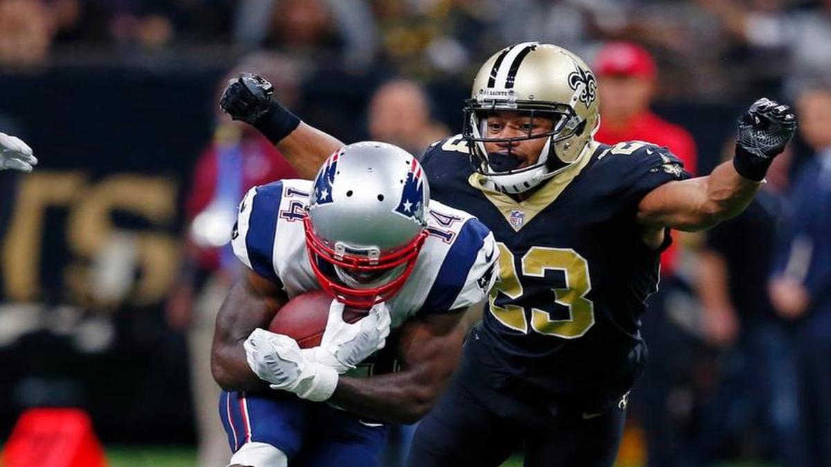 New Orleans Saints cornerback Marshon Lattimore (23) tries to tackle New England Patriots wide receiver Brandin Cooks (14).