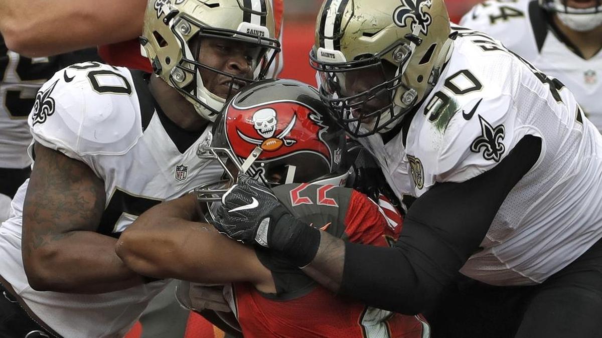 New Orleans Saints outside linebacker Stephone Anthony (50) and defensive tackle Nick Fairley (90) teamed up to stop Tampa Bay Buccaneers running back Doug Martin (22) last season. According to Fox Sports, Fairley has a heart issue.
