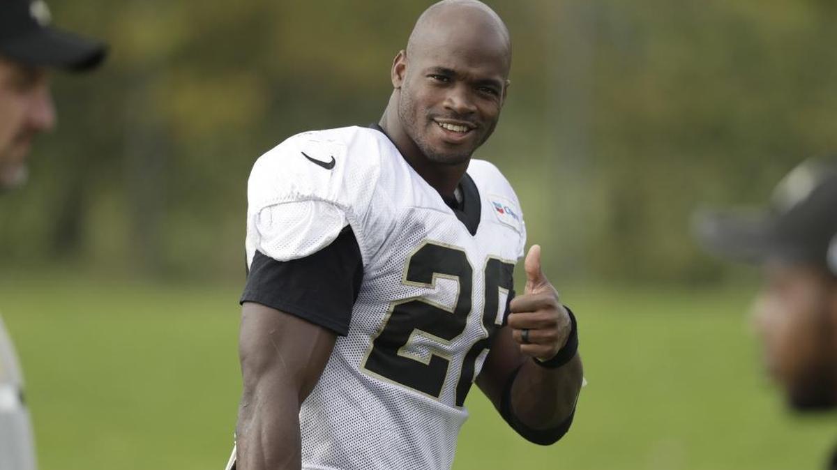 New Orleans Saints running back Adrian Peterson gives a thumbs-up to photographers as he walks off the field after taking part in an NFL training session at the London Irish rugby team training ground in the Sunbury-on-Thames suburb of south west London, Wednesday, Sept. 27, 2017.